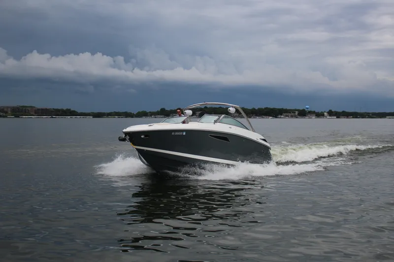 Slide: The Image of 2021 Cobalt R35 Surf boat cruising on a lake under cloudy skies. - 19