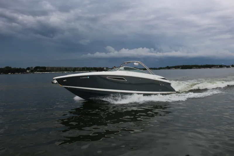 Slide: The Image of 2021 Cobalt R35 Surf boat cruising on a lake under cloudy skies. - 20