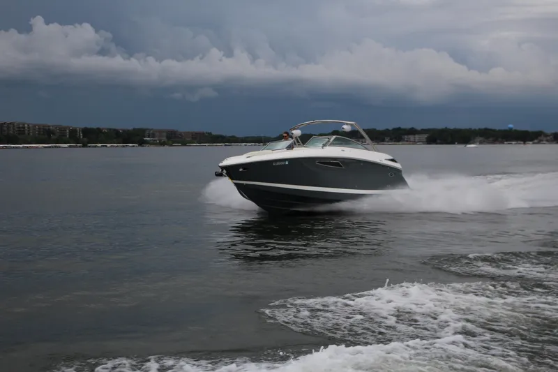 Slide: The Image of 2021 Cobalt R35 Surf boat speeding on a lake under cloudy skies. - 22