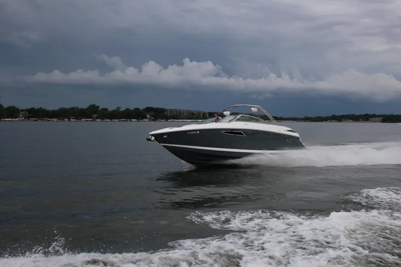 Slide: The Image of 2021 Cobalt R35 Surf boat cruising on a lake under cloudy skies. - 23