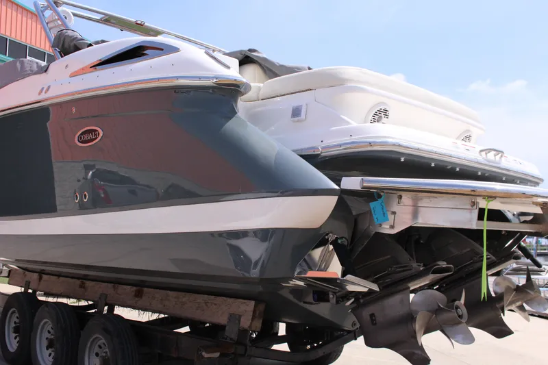 Slide: The Image of 2021 Cobalt R35 Surf boat on trailer, showcasing dual propellers and sleek design. - 32