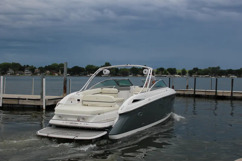 Slide: The Image of 2021 Cobalt R35 Surf boat cruising near a dock on a cloudy day. - 7