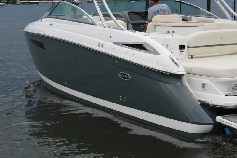 Slide: The Image of 2021 Cobalt R35 Surf boat on water, sleek design, white and gray exterior. - 8