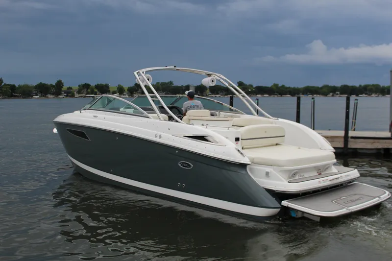 Slide: The Image of 2021 Cobalt R35 Surf boat on a calm lake near a dock. - 9