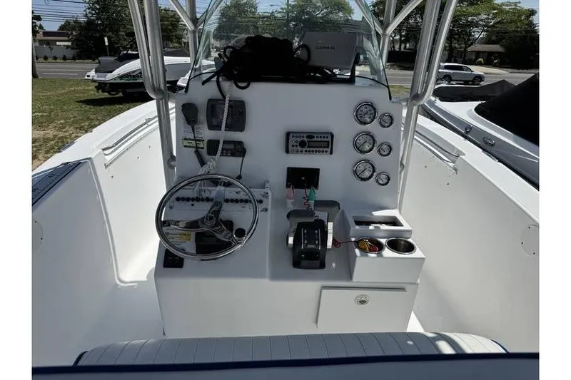 Slide: The Image of 2007 Sea Fox 256 boat dashboard with steering wheel and gauges. - 10