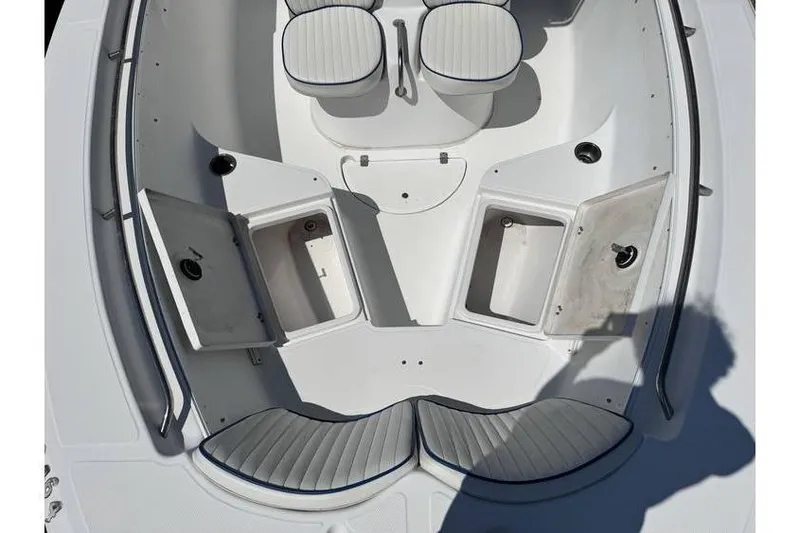 Slide: The Image of 2007 Sea Fox 256 boat interior with open storage compartments and cushioned seating. - 6