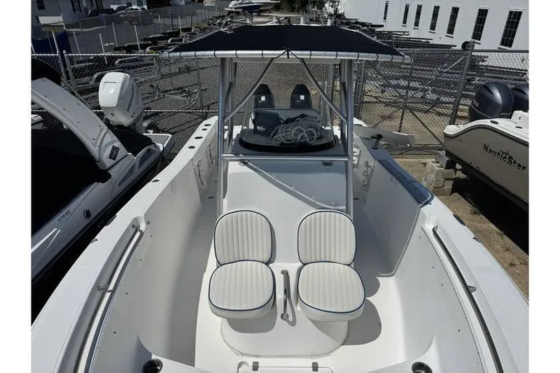 Slide: The Image of 2007 Sea Fox 256 boat with dual seating and canopy, docked in a marina. - 7