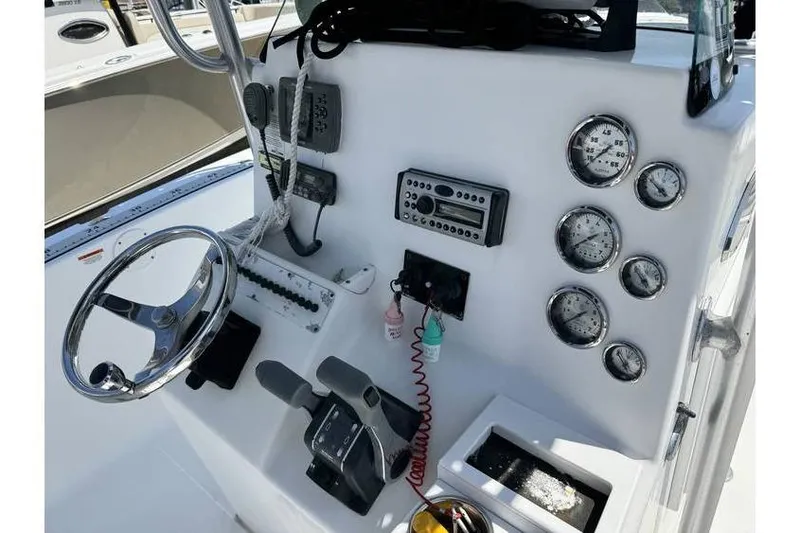 Slide: The Image of Console of a 2007 Sea Fox 256 boat with steering wheel and gauges. - 9