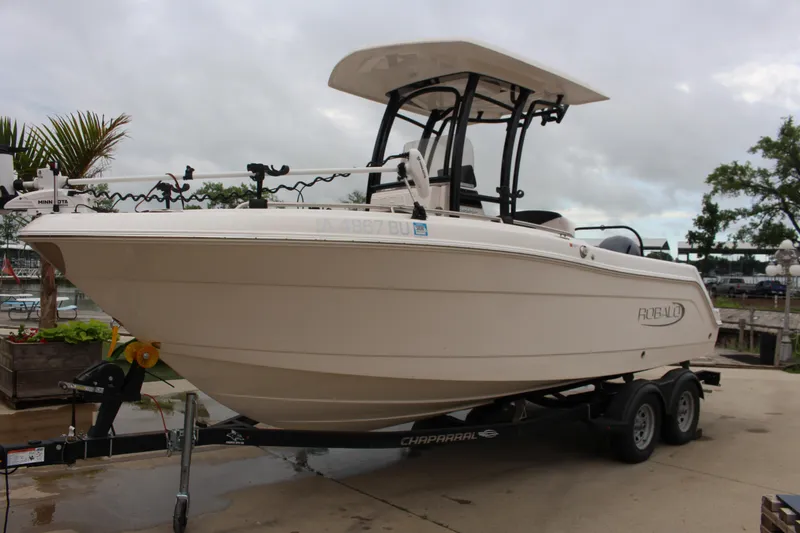 Slide: The Image of 2021 Robalo 222EX boat on trailer, parked outdoors, overcast sky. - 1