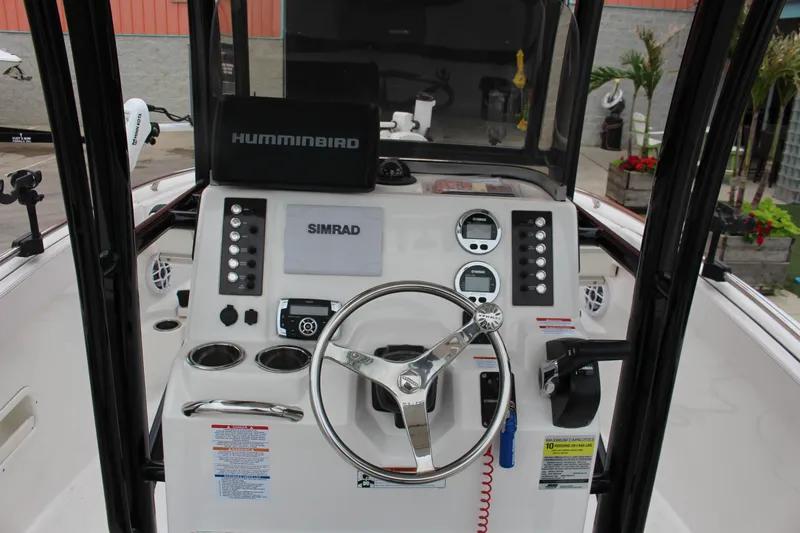 Slide: The Image of 2021 Robalo 222EX boat dashboard with steering wheel, Simrad and Humminbird electronics. - 3
