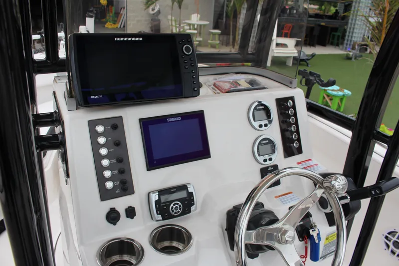 Slide: The Image of 2021 Robalo 222EX boat dashboard with navigation screens and controls. - 4