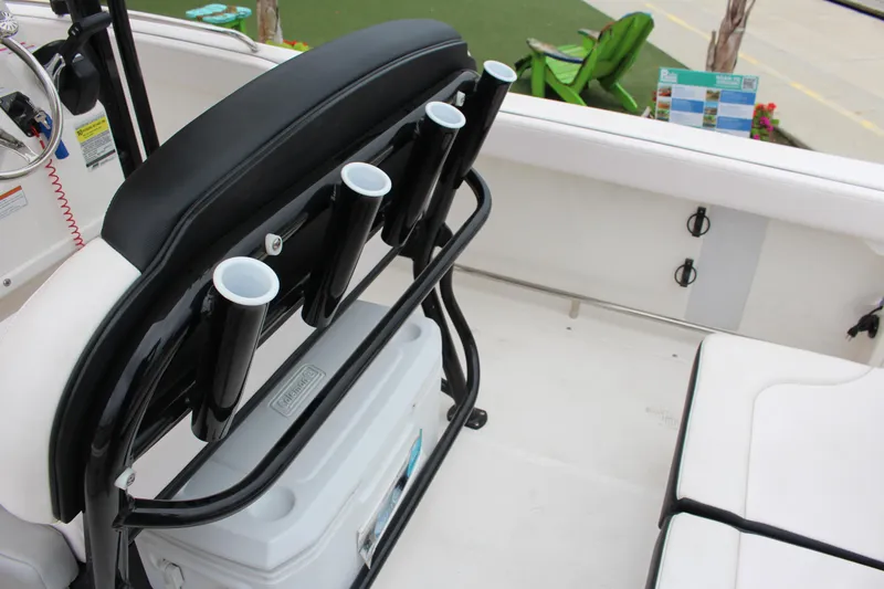 Slide: The Image of 2021 Robalo 222EX boat interior with rod holders and seating. - 8