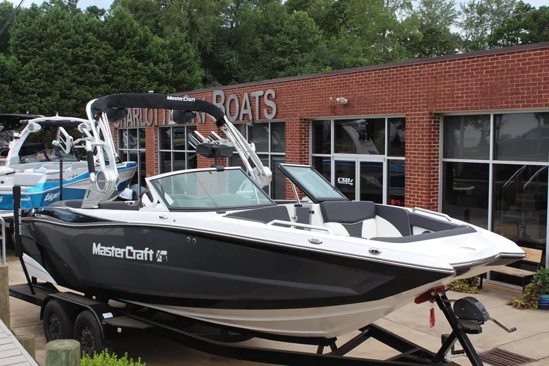 Slide: The Image of 2018 MasterCraft XT22 boat displayed outside a brick building. - 1