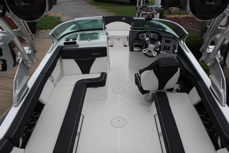 Slide: The Image of 2018 MasterCraft XT22 boat interior with sleek seating and modern dashboard design. - 10