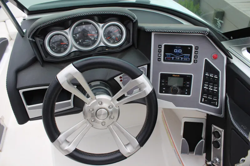 Slide: The Image of 2018 MasterCraft XT22 dashboard with steering wheel and control panel. - 11