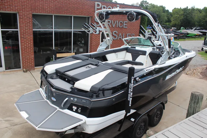 Slide: The Image of 2018 MasterCraft XT22 boat at dealership, featuring sleek design and modern amenities. - 3