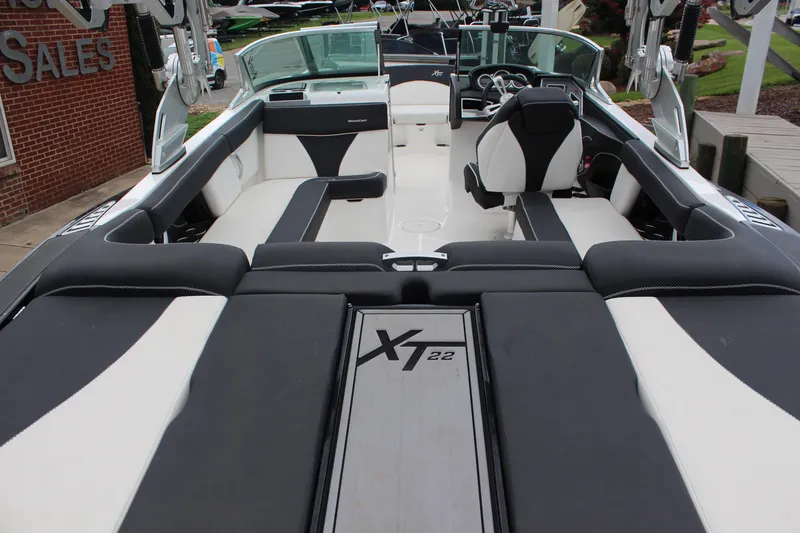 Slide: The Image of 2018 MasterCraft XT22 boat interior with sleek black and white seating design. - 9