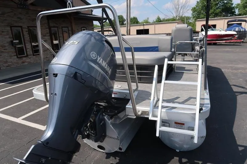 Slide: The Image of 2022 Bennington 23 LSB pontoon boat with Yamaha outboard motor and boarding ladder. - 11