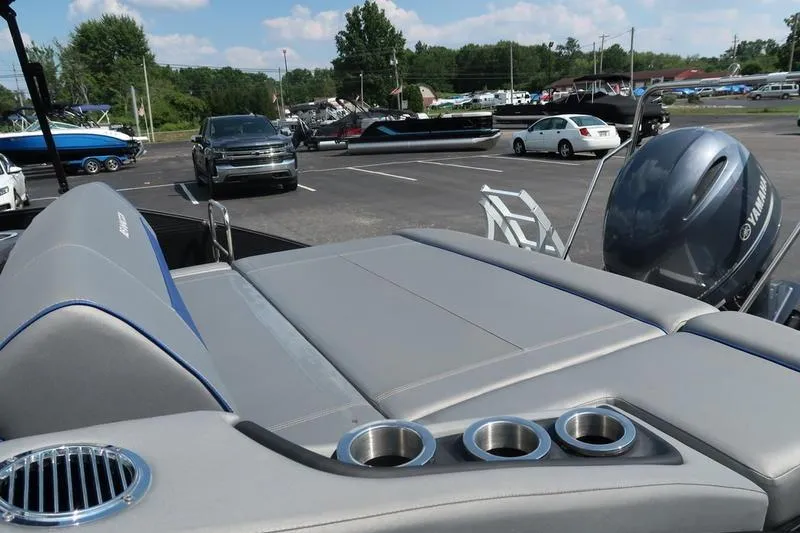 Slide: The Image of 2022 Bennington 23 LSB boat with Yamaha engine in a parking lot. - 13