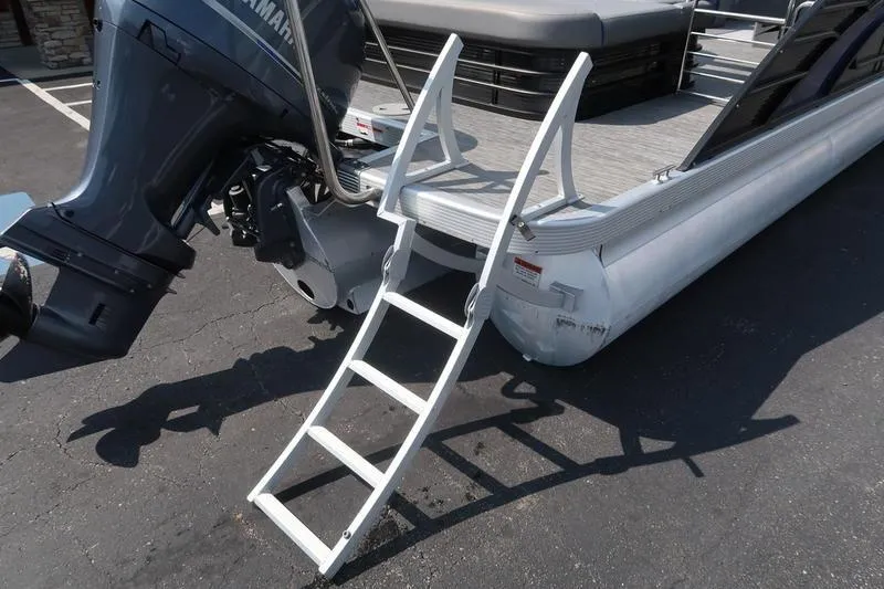 Slide: The Image of 2022 Bennington 23 LSB pontoon boat with ladder and Yamaha outboard motor. - 15