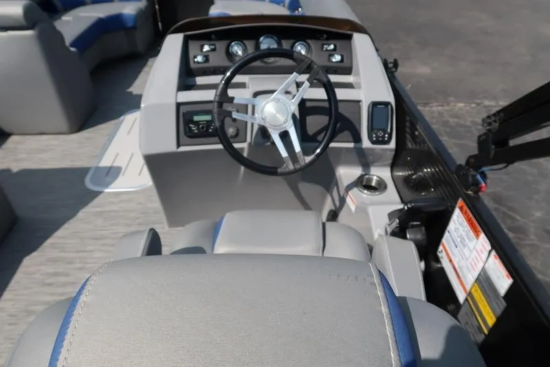 Slide: The Image of 2022 Bennington 23 LSB boat interior with steering wheel and dashboard controls. - 16