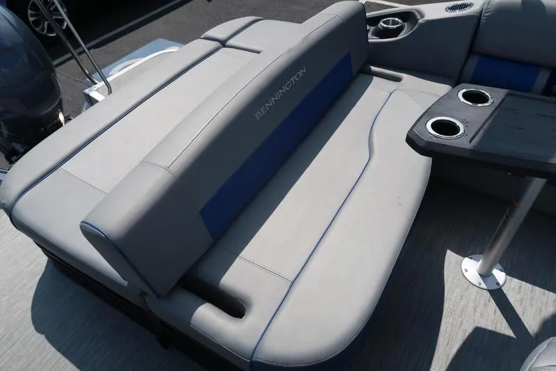 Slide: The Image of 2022 Bennington 23 LSB boat interior with gray seating and cup holders. - 17