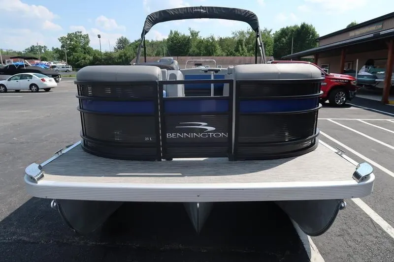Slide: The Image of 2022 Bennington 23 LSB pontoon boat in a parking lot, front view. - 2