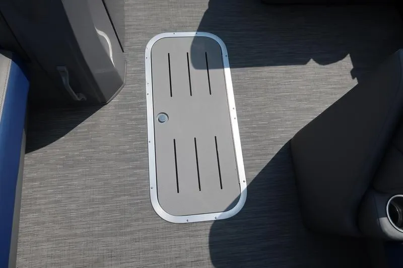 Slide: The Image of 2022 Bennington 23 LSB boat floor with storage hatch and seating area. - 23