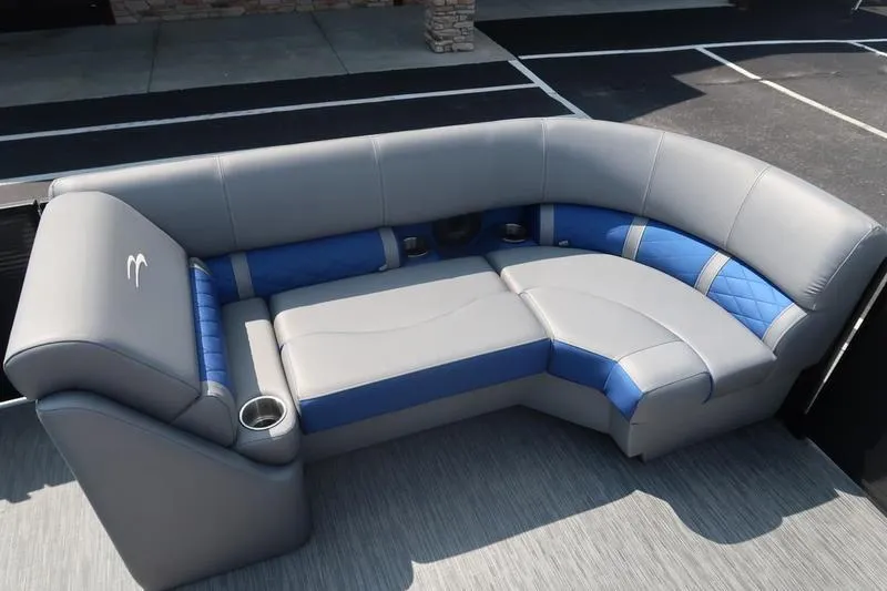 Slide: The Image of 2022 Bennington 23 LSB boat seating, gray and blue upholstery, cup holders, modern design. - 24