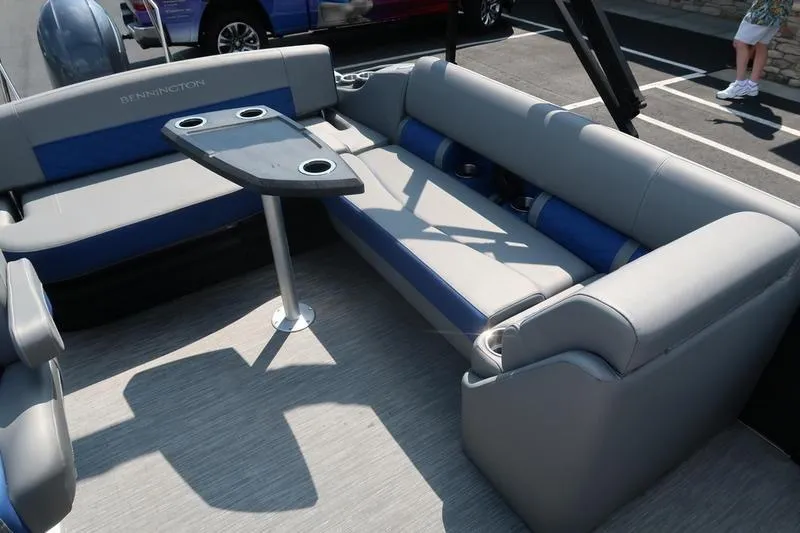 Slide: The Image of 2022 Bennington 23 LSB boat interior with gray and blue seating and table. - 26