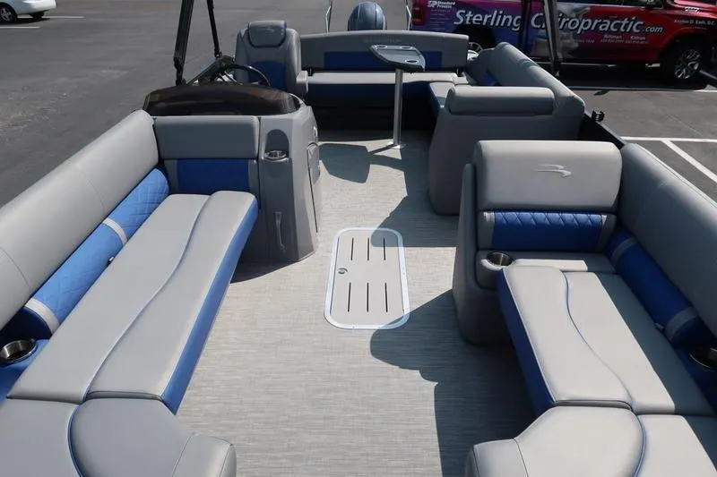 Slide: The Image of 2022 Bennington 23 LSB pontoon boat interior with gray and blue seating. - 27