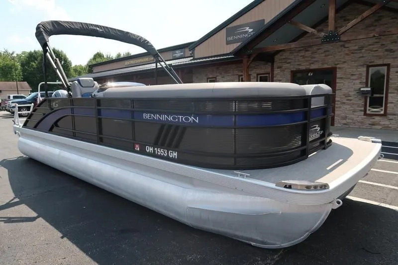 Slide: The Image of 2022 Bennington 23 LSB pontoon boat parked outside dealership. - 3