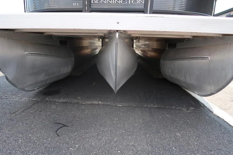 Slide: The Image of Underneath view of 2022 Bennington 23 LSB pontoon boat on pavement. - 4