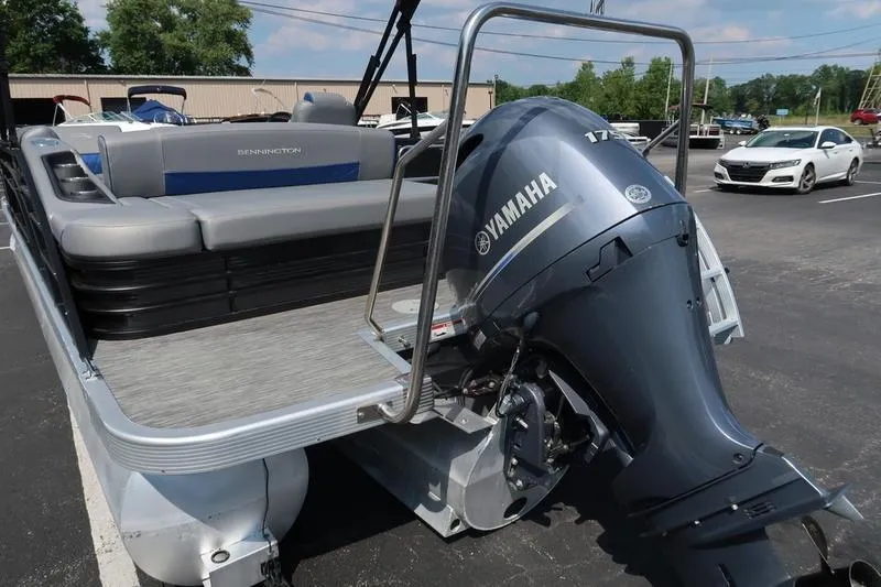 Slide: The Image of 2022 Bennington 23 LSB pontoon boat with Yamaha outboard motor in parking lot. - 5