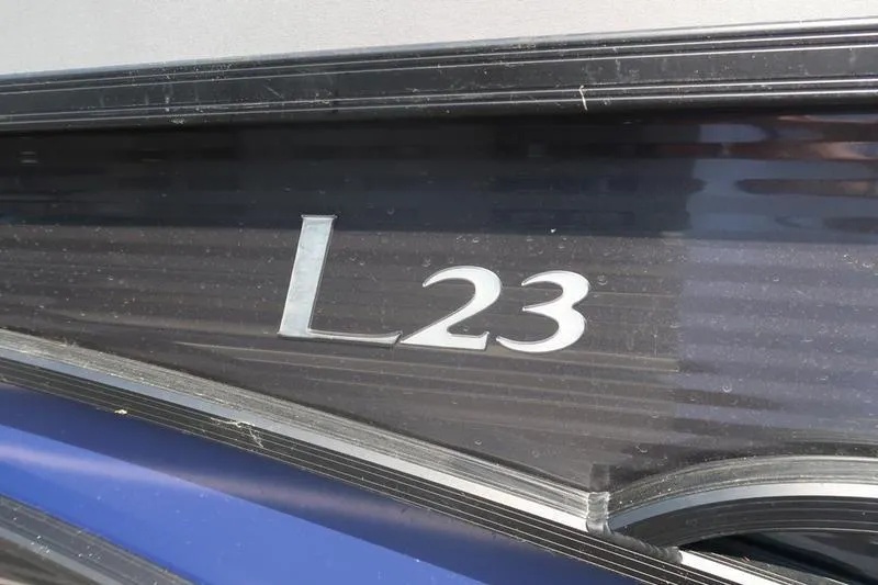 Slide: The Image of 2022 Bennington 23 LSB boat model emblem on sleek black and blue exterior. - 6