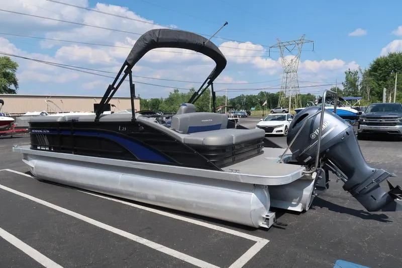 Slide: The Image of 2022 Bennington 23 LSB pontoon boat with Yamaha outboard motor in parking lot. - 9