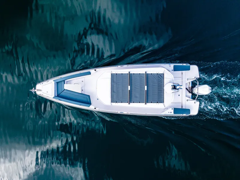 Slide: The Image of Aerial view of 2022 Axopar 28 boat cruising on calm water. - 2