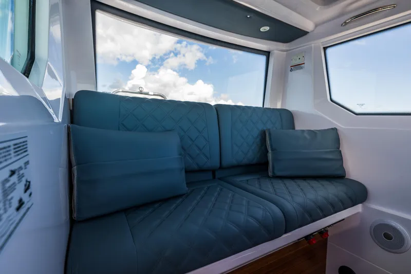 Slide: The Image of Luxurious interior seating of 2022 Axopar 28 boat with blue cushions. - 35