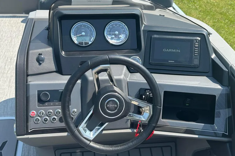 Slide: The Image of 2025 Tahoe 2385 boat dashboard with steering wheel, gauges, and Garmin navigation system. - 12