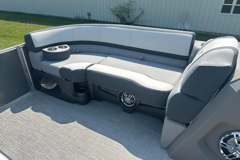 Slide: The Image of 2025 Tahoe 2385 boat interior with gray seating and cup holders. - 15