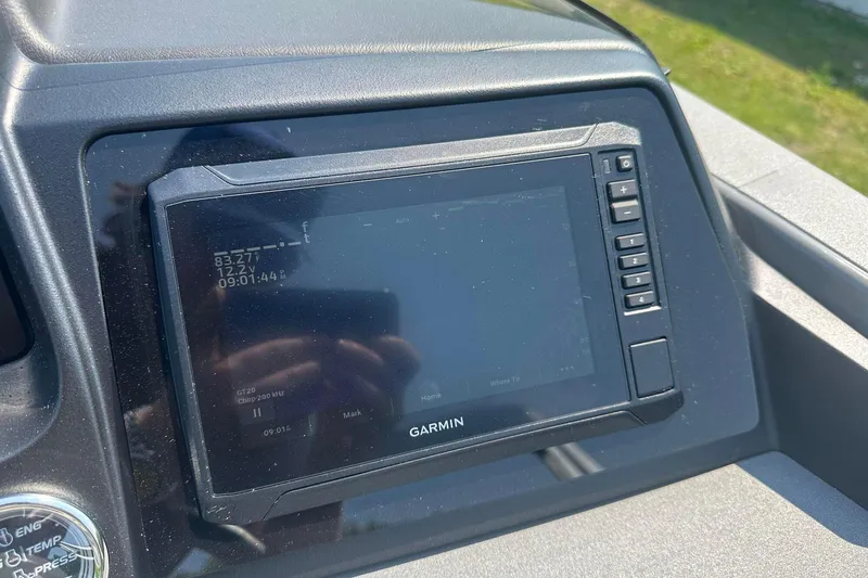Slide: The Image of Garmin display on 2025 Tahoe 2385 boat dashboard, showing temperature and voltage. - 19