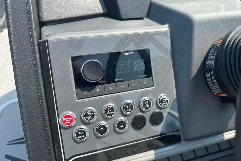 Slide: The Image of Control panel of 2025 Tahoe 2385 boat with audio system and various buttons. - 21