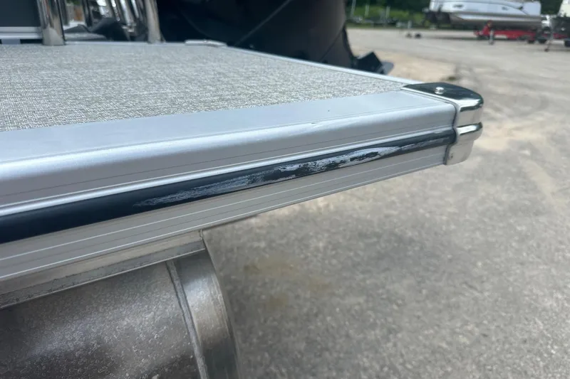 Slide: The Image of Close-up of 2025 Tahoe 2385 boat deck with metal trim detailing. - 27