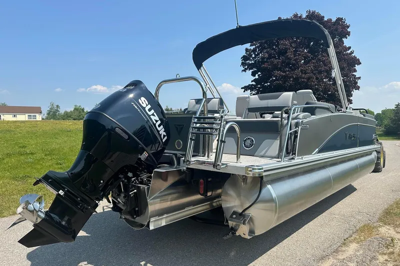 Slide: The Image of 2025 Tahoe 2385 pontoon boat with Suzuki outboard motor on a sunny day. - 5