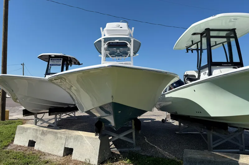 Slide: The Image of 2026 Tidewater 2500 Carolina Bay boats displayed outdoors under clear blue sky. - 16