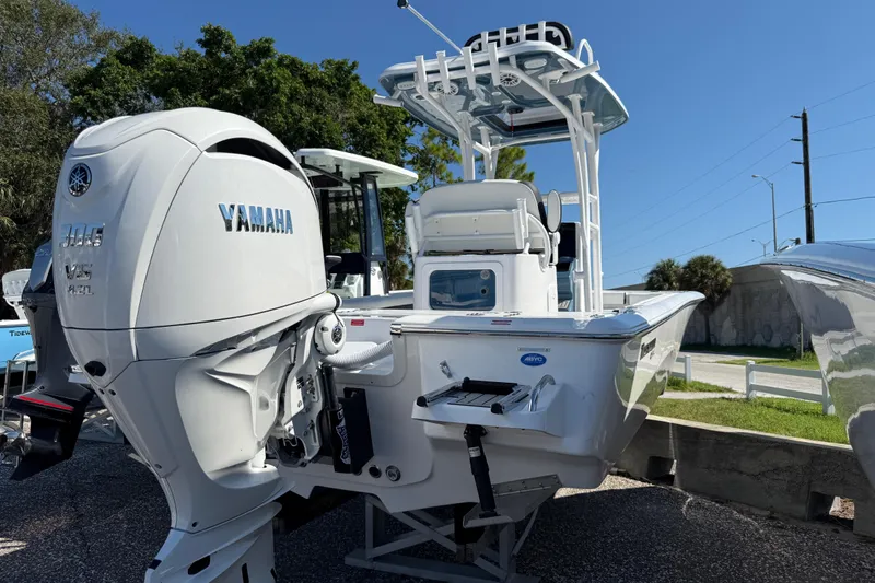 Slide: The Image of 2026 Tidewater 2500 Carolina Bay boat with Yamaha engine, parked outdoors. - 18