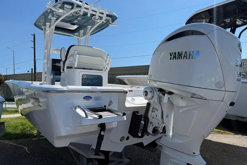 Slide: The Image of 2026 Tidewater 2500 Carolina Bay boat with Yamaha engine, displayed outdoors. - 8
