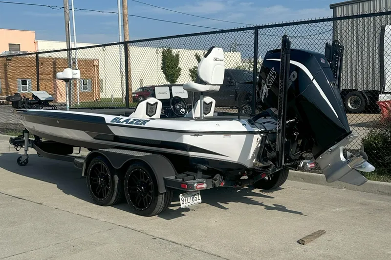 Slide: The Image of 2021 Blazer 650 Pro Tour boat on trailer, parked outdoors. - 10