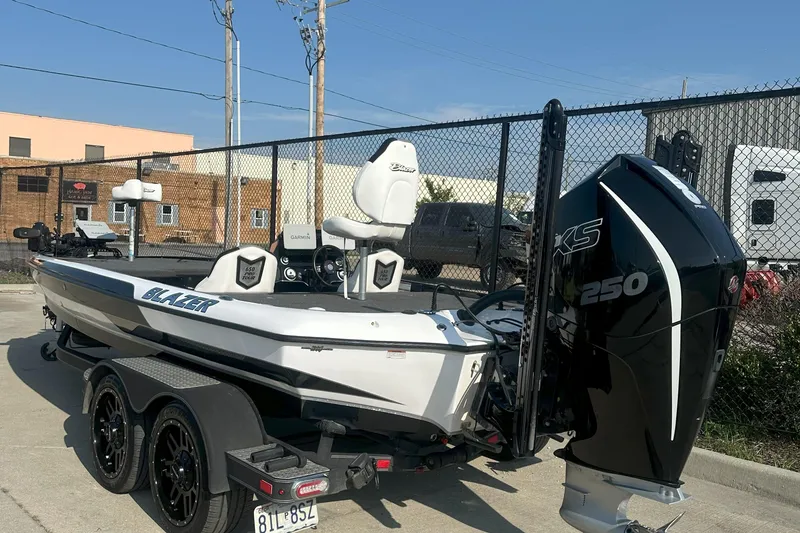 Slide: The Image of 2021 Blazer 650 Pro Tour boat with powerful engine, parked on a trailer. - 11