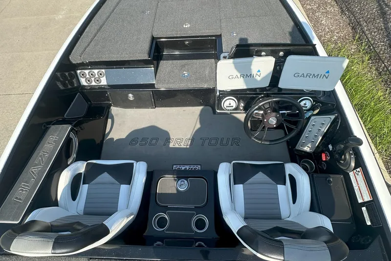 Slide: The Image of 2021 Blazer 650 Pro Tour boat interior with Garmin displays and dual seats. - 15